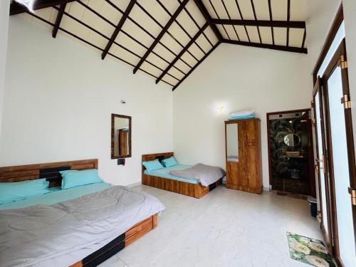 a bedroom with two beds in a room at Serene Pool Villa-Coffee Estate Stay,Mudigere in Mudigere