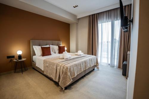 a bedroom with a bed and a large window at Phōs, Light Modern Living in Gaïtánion