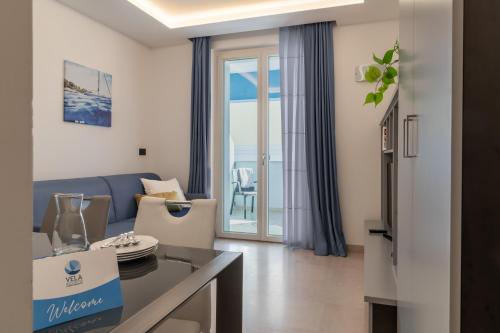 a living room with a couch and a table at Vela Azzurra Holiday Home in Grottammare