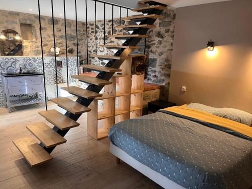 a bedroom with a spiral staircase next to a bed at Maison l ouline in Montferrer