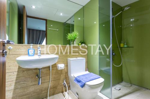 a bathroom with a toilet and a sink and a shower at Vortex Suites Klcc By Homestay in Kuala Lumpur
