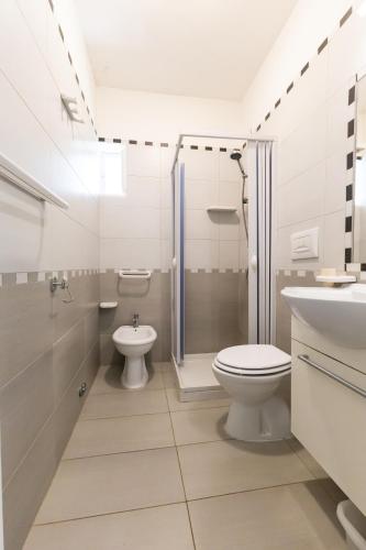a bathroom with a toilet and a shower and a sink at Maison Marie in Vieste