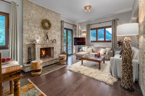 a living room with a couch and a fireplace at the mountain house in parnassus in Eptalofos