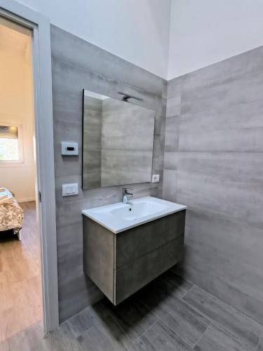a bathroom with a sink and a mirror at The Wine's Sundial AFFITTACAMERE in Aiello del Friuli
