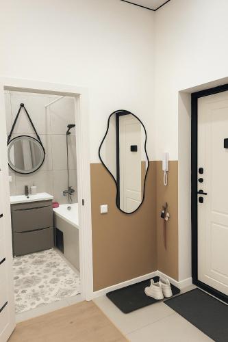 a bathroom with a mirror and a sink at Kolsay in Kirovo