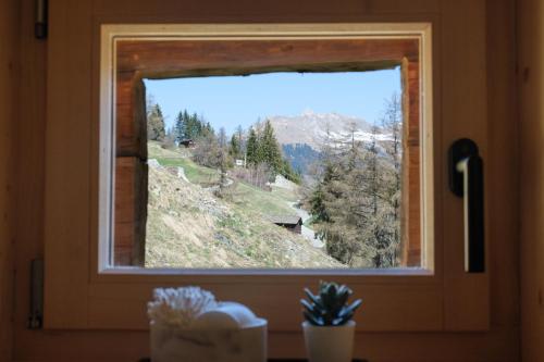 a window with a view of a mountain view at ALTYPIC Mayen d'exception en Valais in Bruson