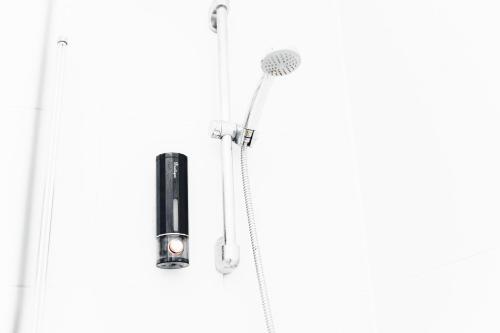 a shower in a bathroom with a blow dryer at Charming GEM II 2BD 2BA Retreat in London