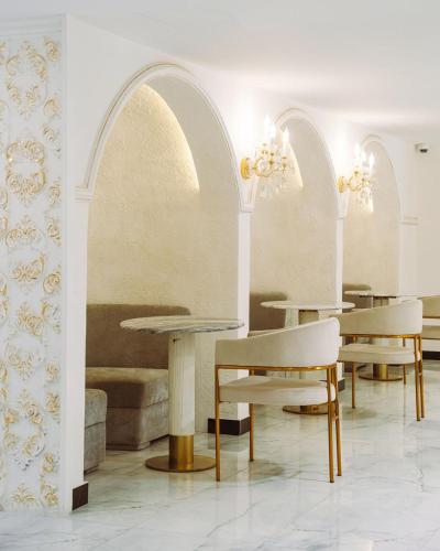 a room with two tables and chairs and a couch at White Domes Hotel in Baghdād