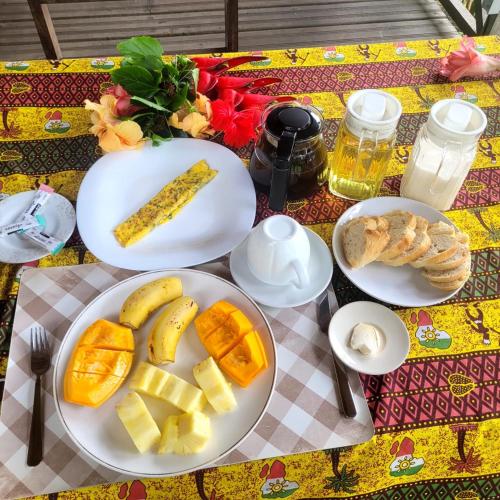 a table with plates of food on a table at Domus Praia Jalé in Água-Côco