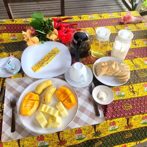a table with plates of food on a table at Domus Praia Jalé in Água-Côco