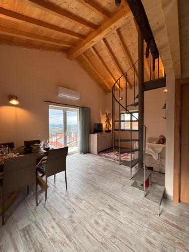 a dining room and living room with a large window at Casa BelaVista Penela - Charming Guest House - Adults Only in Penela