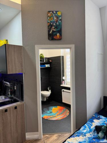 a bathroom with a mirror and a sink and a toilet at Apartment Van Gogh in Osterburg Siedlung