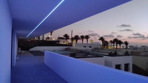 a view of a rooftop with palm trees and purple lights at Casa Calma in Las Breñas