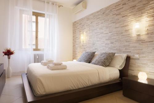 Ένα ή περισσότερα κρεβάτια σε δωμάτιο στο Bilocale moderno a Bollate vicino a Fieramilano e Milano Ice Park