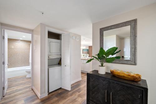 a kitchen with a counter with a sink and a mirror at Kaanapali Shores 527 · KS 527 2Bedroom w Ocean Views in BeachFro in Kahana