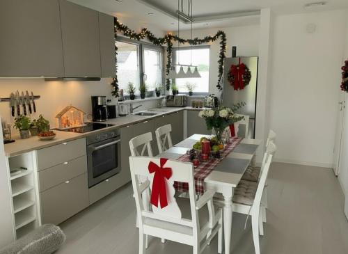 a kitchen with a table with a red bow on it at Casa Milo - Trzęsacz in Trzęsacz