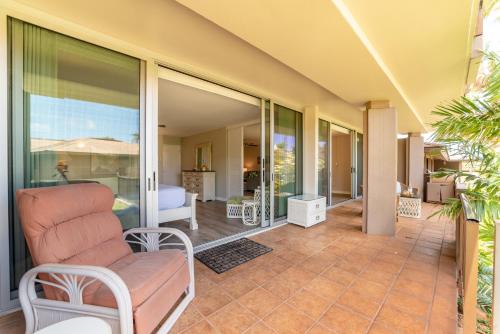 a living room with a couch on a patio at Eldorado E104 · Spacious 1BD wPool at Kaanapali in Kahana