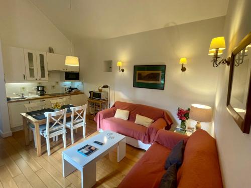 a living room with a couch and a table at Quinta Das Faias in Camacha