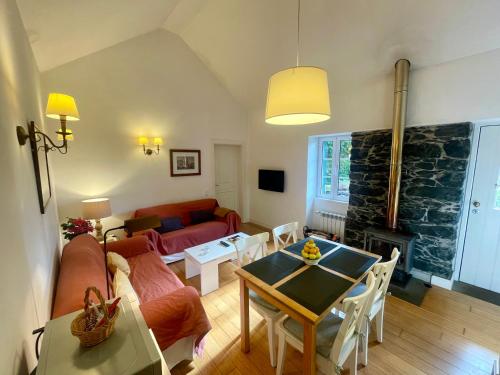 a living room with a couch and a table at Quinta Das Faias in Camacha