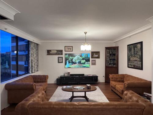 a living room with couches and a coffee table at Garden Gallery - Tranquil Luxury Retreat in Canberra