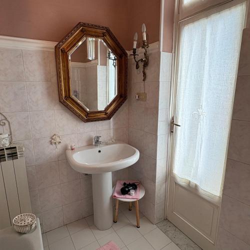a bathroom with a sink and a mirror at LeaLua Apartments - Casa Mirella in Novi Ligure