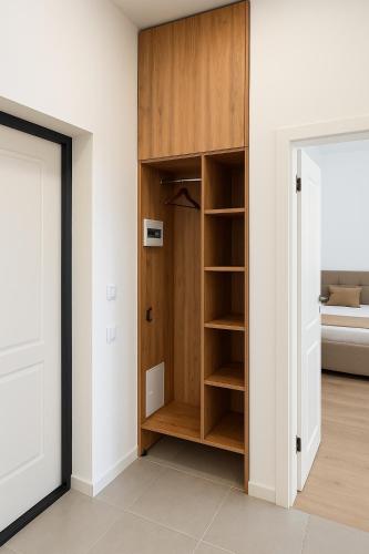 a room with a wooden closet with a bed at Kolsay in Kirovo