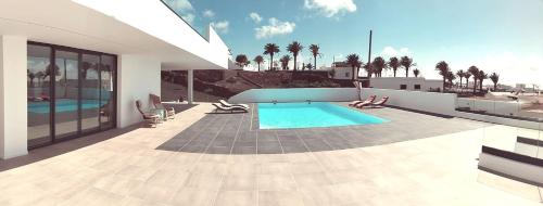a swimming pool on the side of a house at Casa Calma in Las Breñas