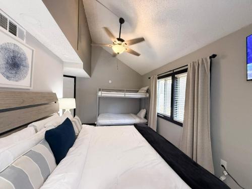 a bedroom with a bed and a ceiling fan at Lakefront Home-3bd25badockgrillfirepitpool in Arrowhead Beach