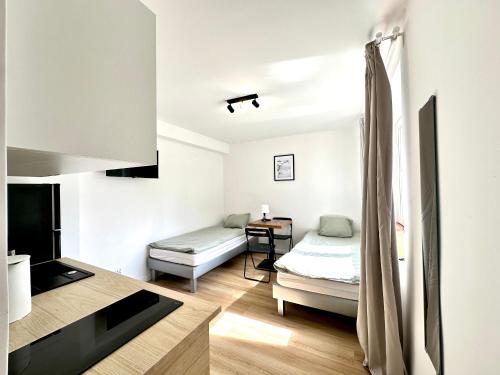 a room with two beds and a television in it at leszczynki parter III in Gdynia