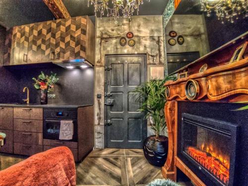 a living room with a fireplace and a door at Esmeralda centre historique in Aix-en-Provence