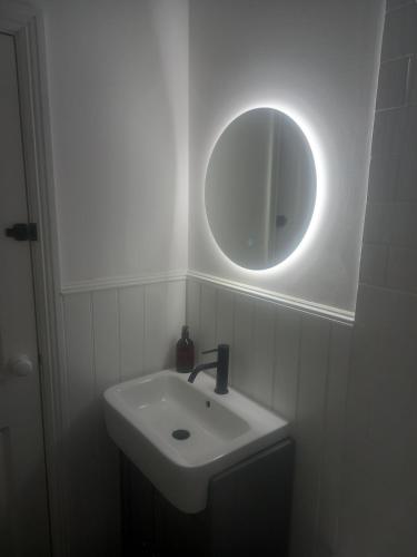 a bathroom with a sink and a mirror at Clubhouse, North End, Bedale DL8 1AB in Bedale