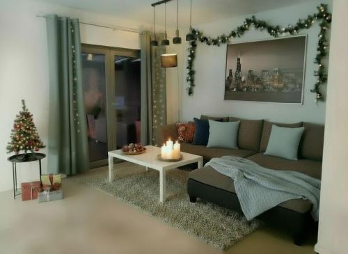 a living room with a couch and a table with candles at Casa Luisa - Trzęsacz in Trzęsacz