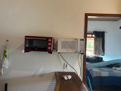 a microwave on the wall of a room at Apartamentos da Casa Azul in Trancoso