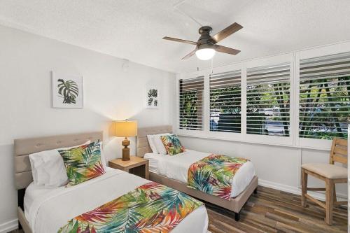 a bedroom with two beds and a ceiling fan at Kamaole Sands 1101 · KAS 1101 Updated Beachy Chic 2BD Across Bea in Wailea
