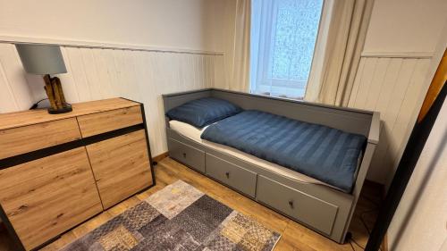 a bedroom with a bed and a dresser and a window at Ferienwohnung Dörfl in Glödnitz, Carinthia in Glödnitz