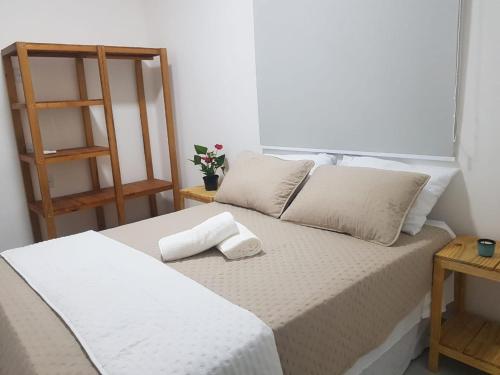 a white bed with two pillows on top of it at Villas do paraíso brisa in Marau