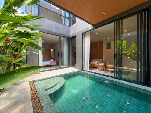 an indoor swimming pool in a villa at Luxury 3-Bedroom Pool Villa Long One B9 with Panoramic Chalong Bay View in Ban Bo Rae