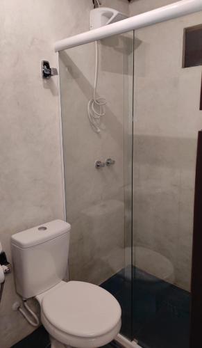 a bathroom with a toilet and a glass shower at Cabana Candeia in Palmeiras