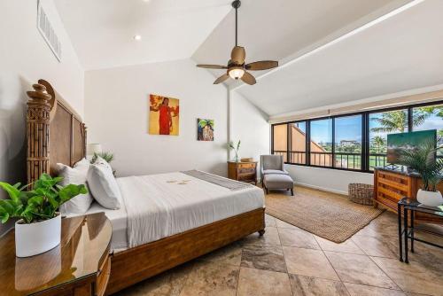 a bedroom with a bed and a ceiling fan at Kaanapali Royal A303 · KRL A303 Relaxing Hawaiian 2BD on Golf Co in Lahaina