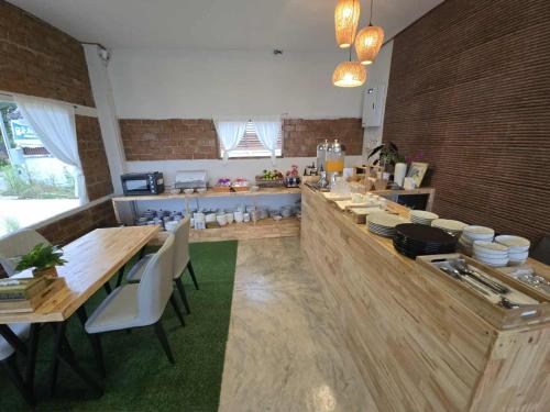 a kitchen with a long table with white chairs at Pai Pavilion in Pai