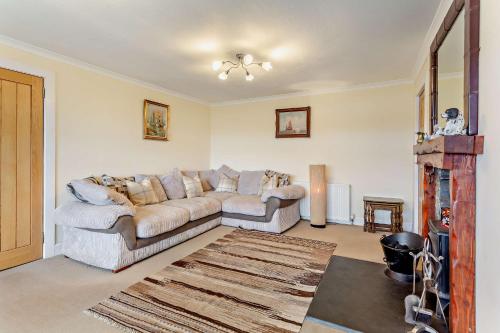 a living room with a couch and a fireplace at Hillside in Kyleakin