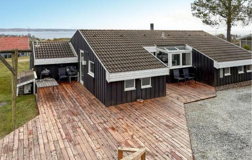 an aerial view of a black house with a deck at Amazing Home In Ebeltoft With Sauna in Ebeltoft