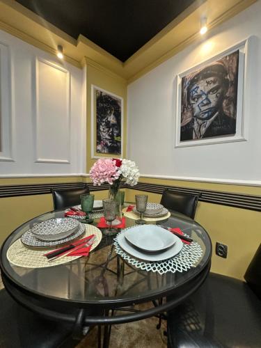 a dining room with a glass table and chairs at Courtyard Central Premium Apartment in Craiova