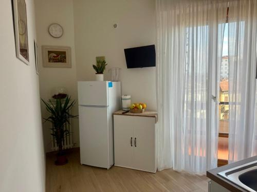 a kitchen with a white refrigerator and a window at Casa La Perla in Montevarchi