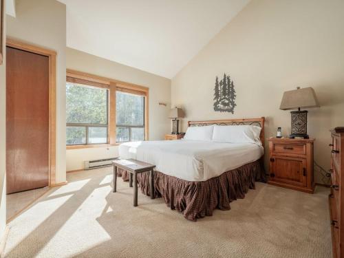 a bedroom with a large bed and a window at RMR: Primrose 1711 Condo in The AspensWilsonWY in Wilson