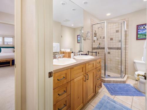 a bathroom with two sinks and a shower at RMR: Snow Ridge 4 Condo in Teton Village in Teton Village