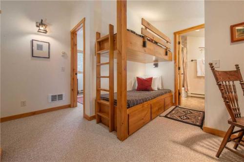 a bedroom with a bunk bed with a ladder at RMR: Strawberry 3922 Condo in The AspensWilsonWY in Wilson