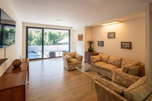 a living room with two couches and a table at Beautiful house 15 min away from Bilbao in Llodio