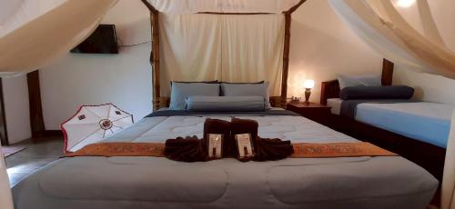 Postel nebo postele na pokoji v ubytování Srichaiyapura Wellness Resort