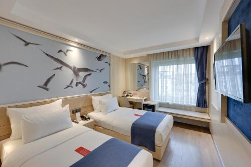 a hotel room with two beds and a tv at Ramada by Wyndham Istanbul Old City in Istanbul